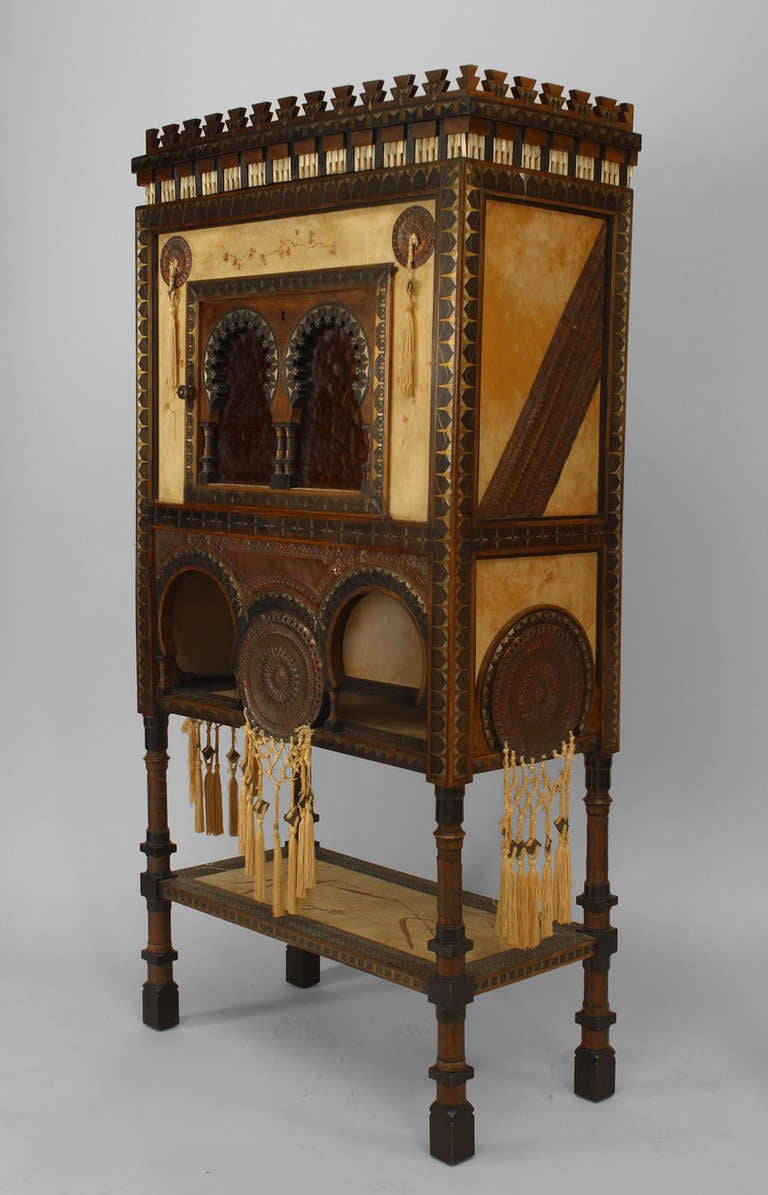 With a provenance that includes ownership by the Cooper-Hewitt Museum, this wooden Middle Eastern style cabinet dates to 1900 and is signed by the world-renowned designer Carlo Bugatti. The piece is elaborately carved with decorative Islamic motifs