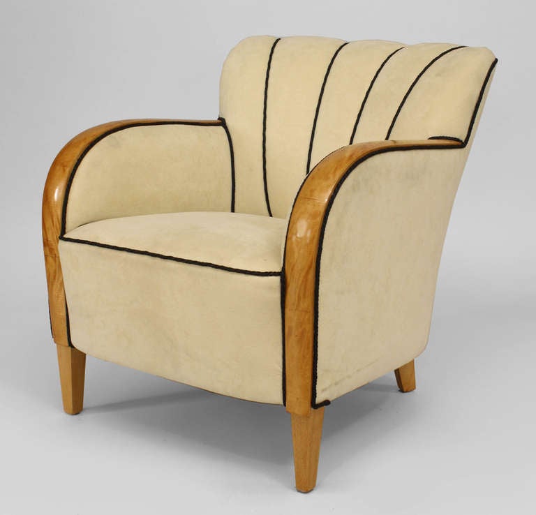 Twentieth century Swedish Biedermeier maple-framed club chair. With the exception of its arms and four legs, the chair is fully upholstered in white fabric trimmed in black piping, accentuating its flair back design.