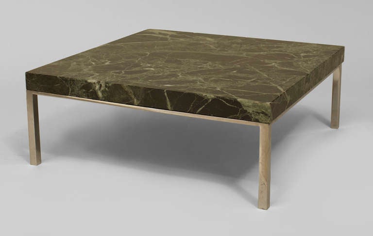 1960's American low coffee table originally designed for Chase Bank's executive offices by Skidmore, Owings, and Merrill. The square table features a thick slab veined green marble top supported by a simple, four-legged chrome frame.