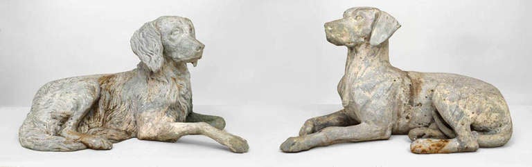 Pair of 19th century English life-sized, cast lead sculptures of reclining dogs sculpted in a highly naturalistic style.
