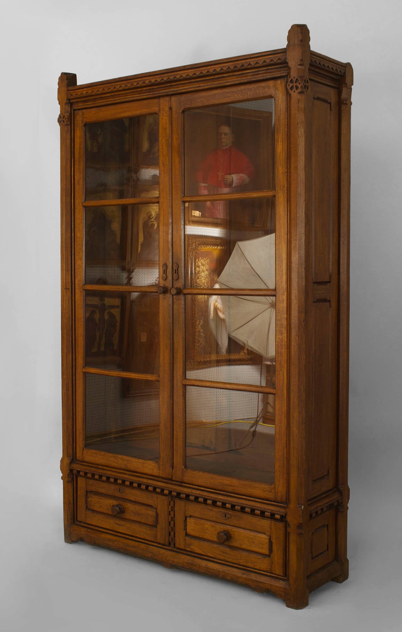 Pair of English Arts and Crafts (Aesthetic Movement) two glass door oak bookcase
cabinets with two bottom drawers and carved geometric trim and four shelves.