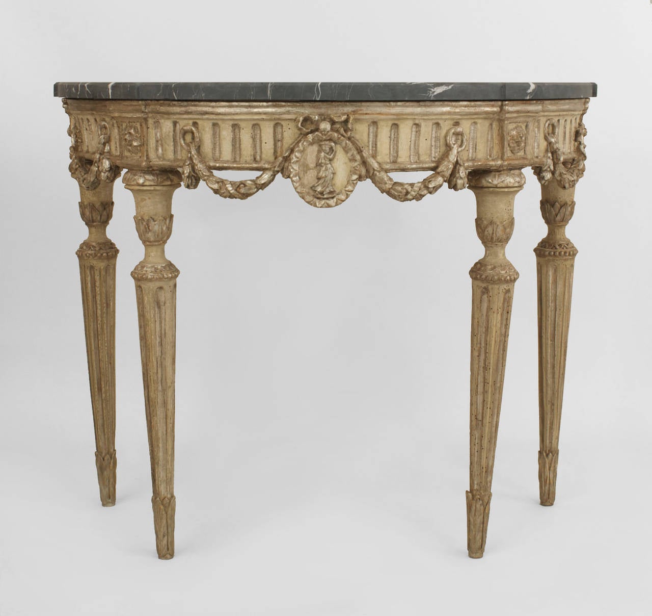 Pair of Italian neoclassic demilune silver-gilt and grey painted console tables
with a fluted apron having a central medallion flanked by garland swags over fluted legs supporting a marble top.