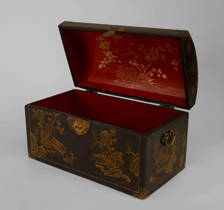 Asian Chinese black lacquered floor trunk with a rounded arch shaped top and decorated with Chinese genre scenes and having a red painted and parcel gilt interior.

