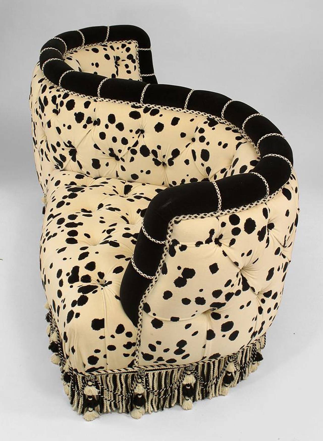 French Victorian style (modern) tufted upholstered velvet tete-a-tete with dalmation design fabric and fringe at base
