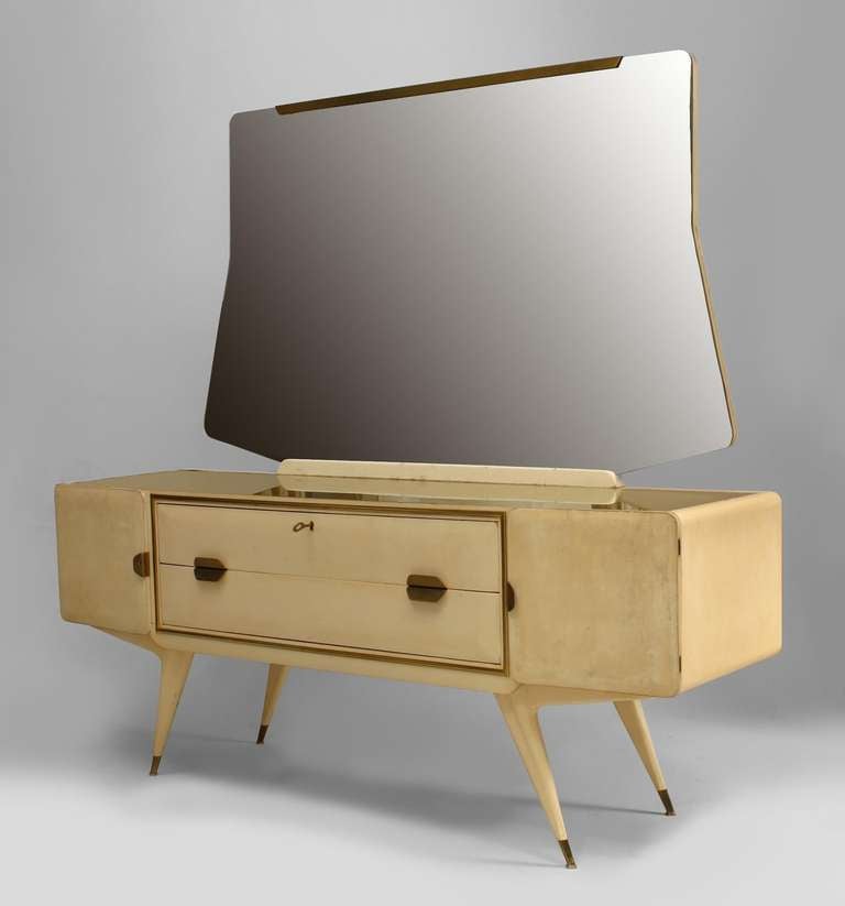 Italian Mid-Century (1950s) white lacquered dresser with 2 doors centering a Pair of gilt framed drawers under a gold glass top supporting a large mirror with brass trim and handles (Attributed to GIO PONTI)
