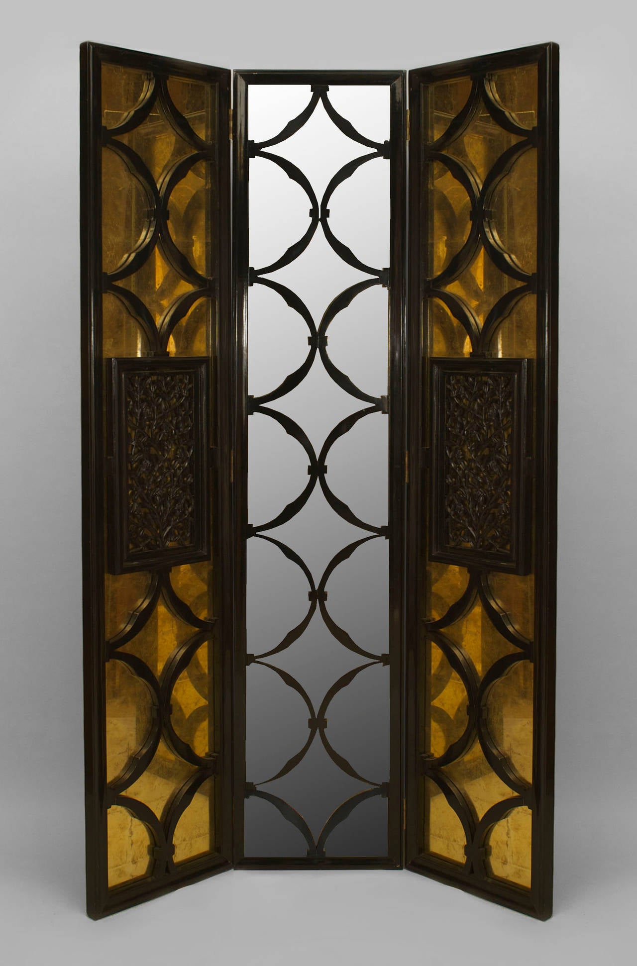 French post-war design black lacquer and parcel-gilt mirrored three panel screen with two filigree carved center panels and half circle design (Maison Jansen 1970s).