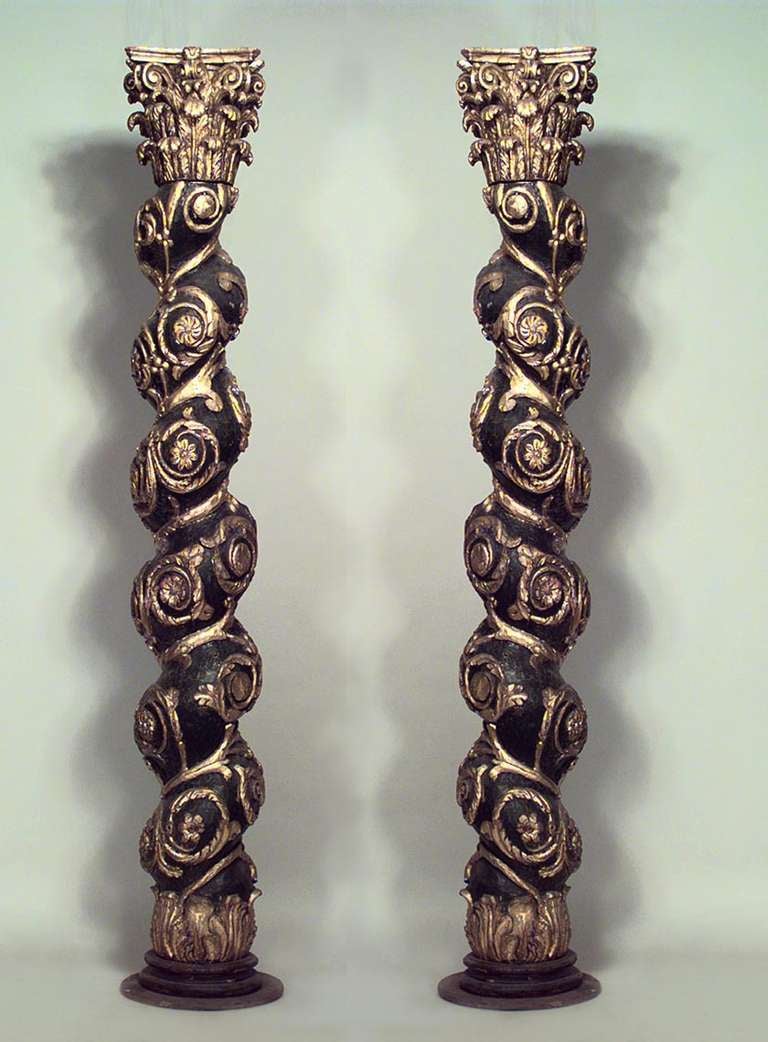 Pair of Italian Baroque style (19th Century) painted black swirl columns with gilt trim and floral and scroll design (PRICED AS Pair).
