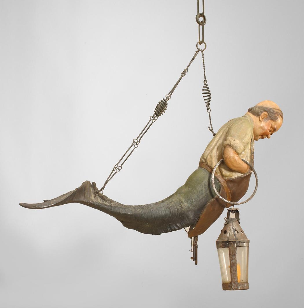 Austrian Tyrolean style (second half of the 19th century) polychromed gesso/wood figural
hanging lamp in the form of a shop keeper with lantern and key and double horn tail.