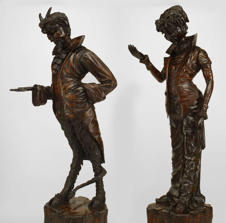 Pair of Italian Renaissance style (19th Century) walnut life-size carved figures of the Devil and his wife standing on pedestal bases. (PRICED AS Pair)

