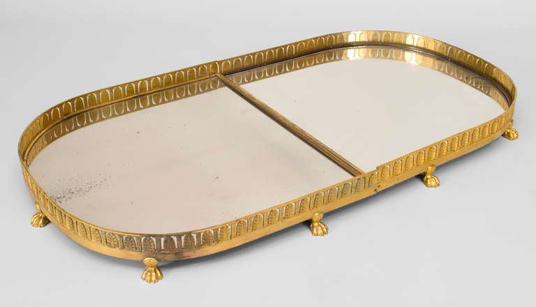French Charles X (1st Quarter 19th Century) centerpiece (sur tout de table) with a gilt bronze filigree gallery over a mirrored surface and paw feet.
