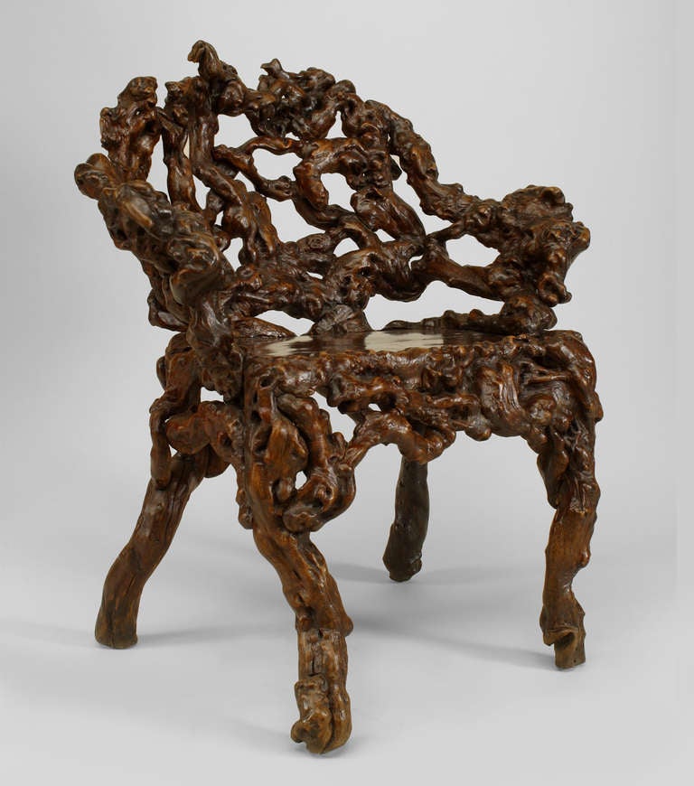 Eighteenth century Chinese rustic armchair composed of carved intersecting roots with a wide, rounded back and a burl wood seat over four legs.
