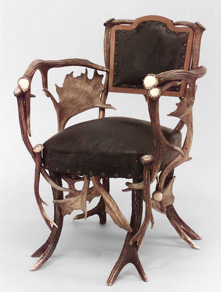 Nineteenth century rustic German oak and antler armchair upholstered in black leather at its seat and back