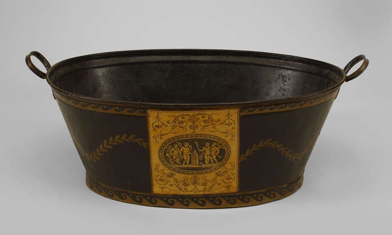 French Victorian black tole oval planter with side handles and decorated with gilt trim.
