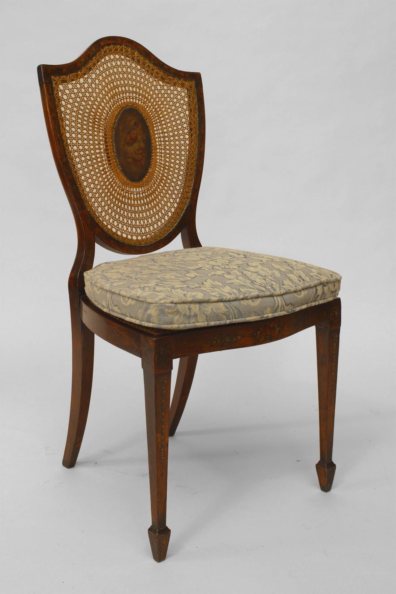 Pair of English Sheraton style (19th Cent) satinwood shield back side chairs with painted and cane back panels.
