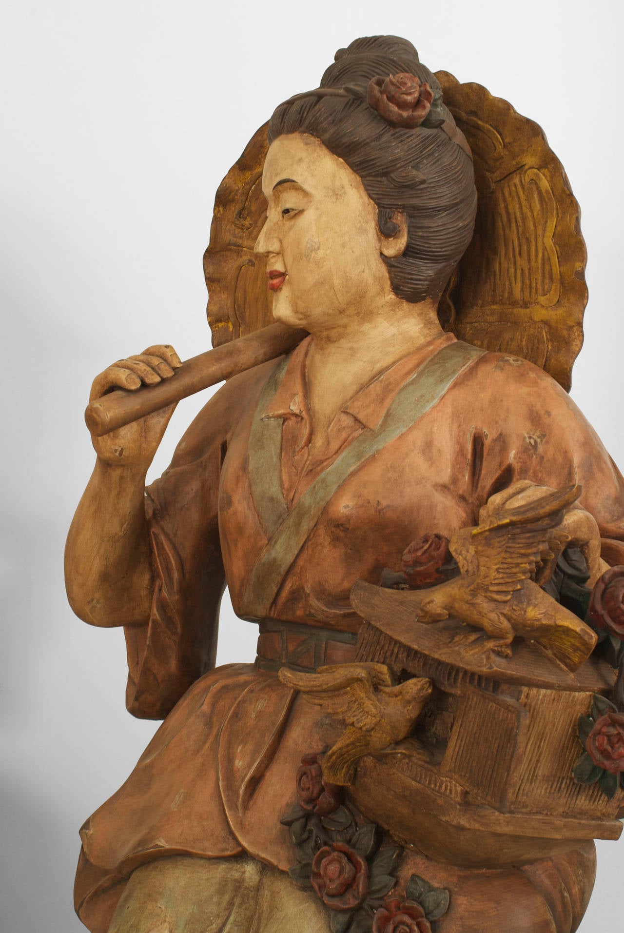 Pair of Asian Chinese style (1960s) decorated terra-cotta life size seated figures in classical dress holding an umbrella
