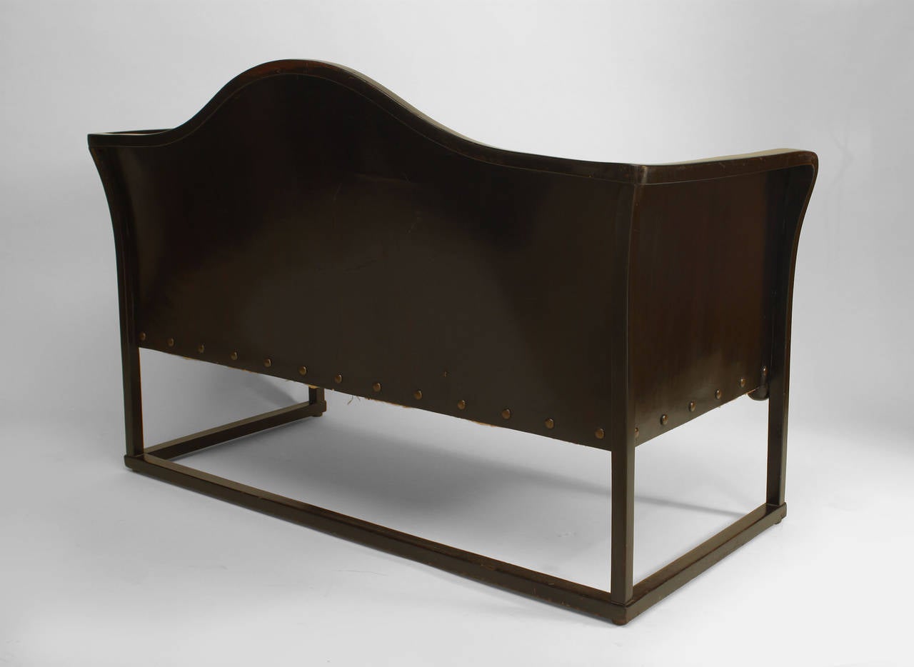 Austrian Bentwood Secessionist stained beechwood loveseat with brown leather seat, back, and sides with ball decoration by legs & box stretcher. (labeled: JACOB & JOSEPH KOHN, WEIN)
