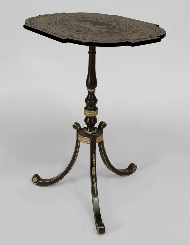 Twentieth century English Regency style ebonized pedestal base end table supported by three splayed legs and featuring a top decorated with floral pattern penwork and a scene of two figures playing.