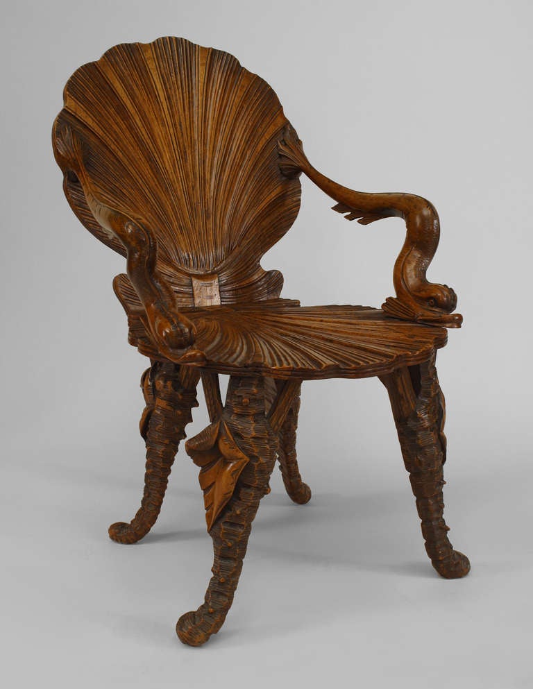 Nineteenth century Venetian grotto fruitwood armchair featuring carved shell-form back, seat, and legs and scrolling dolphin design arms.