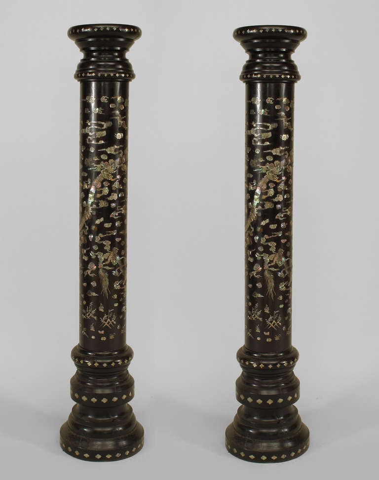 Pair of Asian Chinese style (19th Cent) ebonized wood round 3 section pedestals with pearl inlaid floral and dragon design.
