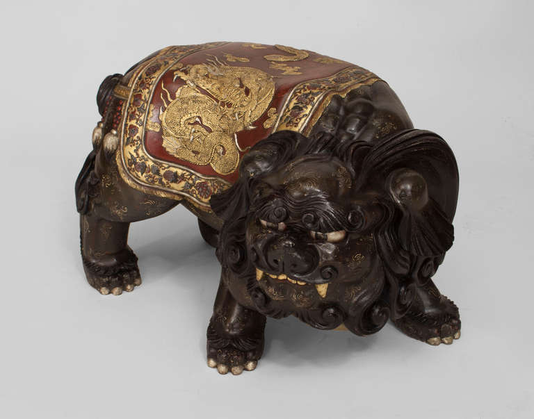 Large pair of late nineteenth or early twentieth century Japanese left and right foo dog (shi-shi) figures. These figures, which double as benches, are carved, lacquered and parcel gilt to achieve a great level of ornament and physical expression,