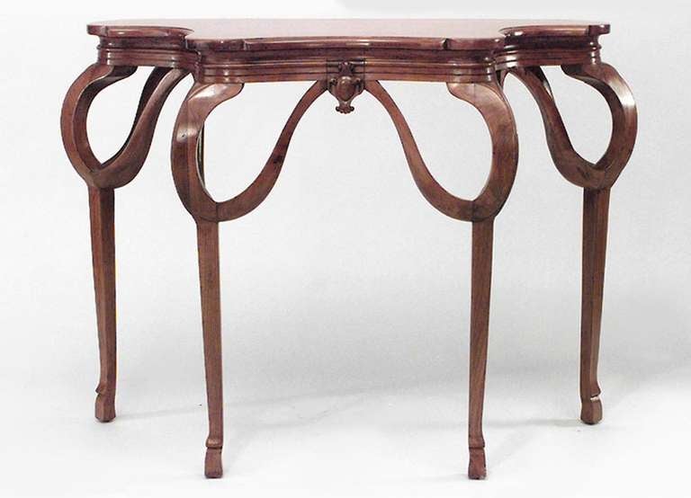 Pair of French Art Nouveau walnut console tables with shaped tops and delicate swag form aprons.