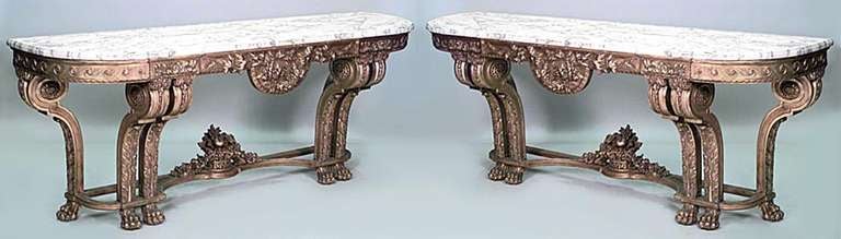 Pair of French Louis XVI-style (Late 19th Century) giltwood console tables with white marble top above a laurel wreath carved frieze on voluted legs joined by a stretcher with basket (PRICED AS Pair)
