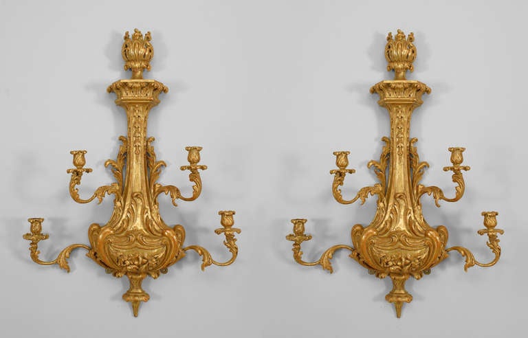 Pair of English Georgian-style (Mid-19th Century) giltwood wall sconces with two tiers of two scroll arms each, a kettle-shaped form with a carved floral design, and top and bottom finials (PRICED AS Pair)
