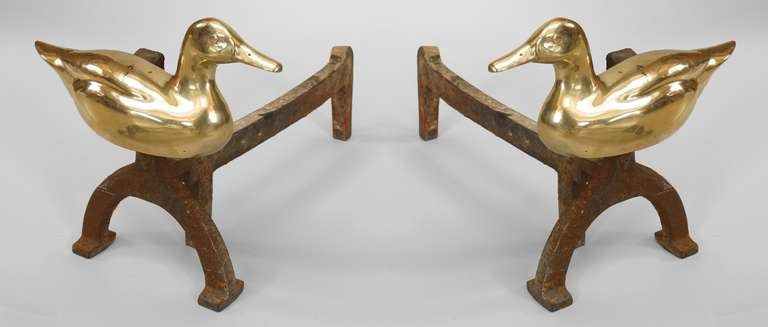 Pair of Rustic Adirondack-style brass duck form andirons mounted on wrought iron horseshoe shaped front shanks. (PRICED AS Pair)
