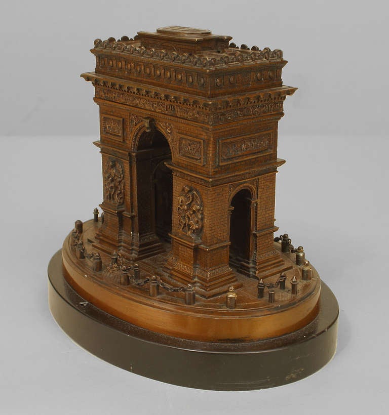 Bronze model of Paris' Arc de Triomphe raised upon an oval black marble base.