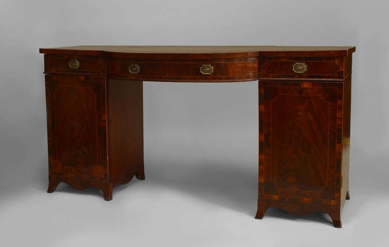 English Georgian (18th Century) mahogany satinwood banded sideboard or desk with a bow front supported by a double pedestal base. (3 sections)
