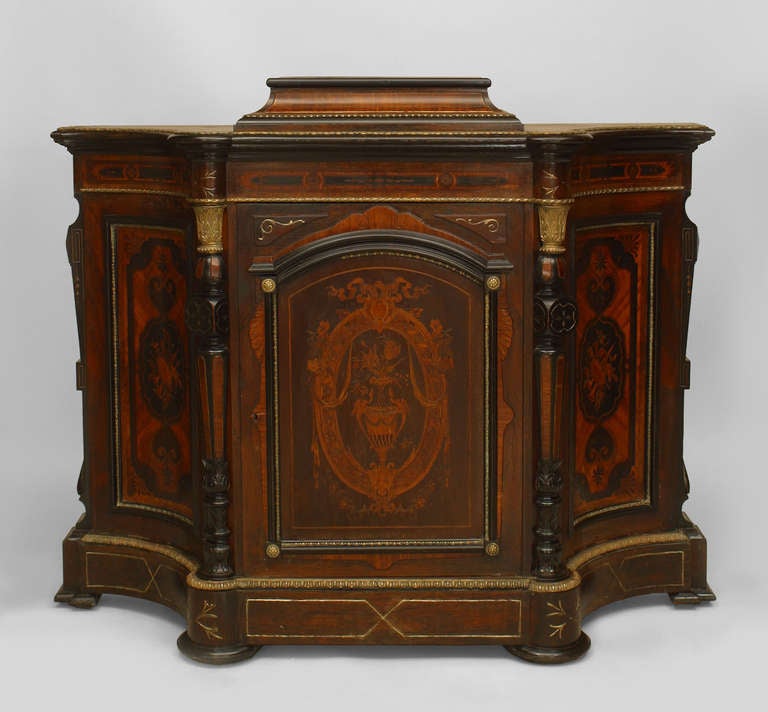 Nineteenth century American Eastlake rosewood credenza raised upon a center platform. The piece features bronze and ebonized trim, as well as decorative inlay at its front door and two concave side panels.