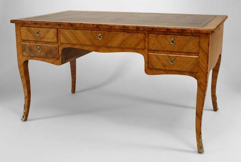 French Louis XV style (19th Century) kingwood veneer desk with 5 drawers and gold tooled leather top with bronze sabot feet and escutcheons.
