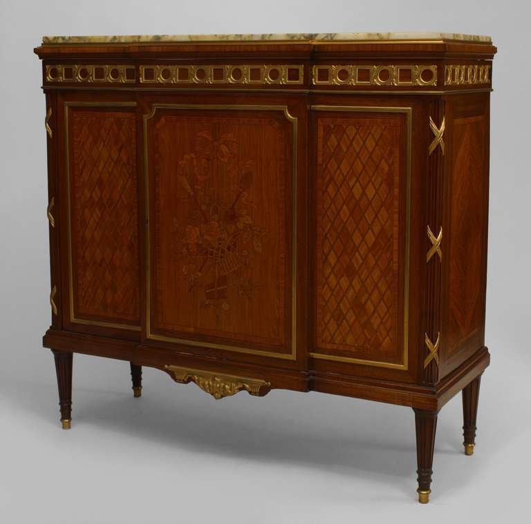 Nineteenth century Louis XVI style parquetry inlaid sideboard cabinet featuring gilt bronze mounts and sabot feet as well as two front doors with inlaid floral marquetry fronts beneath a rectangular marble top.