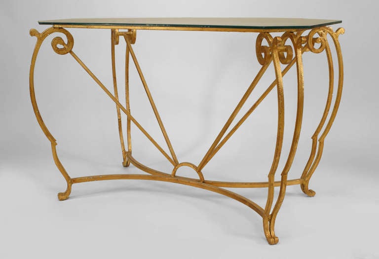 French 1940s gilt iron rectangular center table with double scroll design corners connecting to a stretcher with a new glass top. (attributed to JEAN-CHARLES MOREUX).
