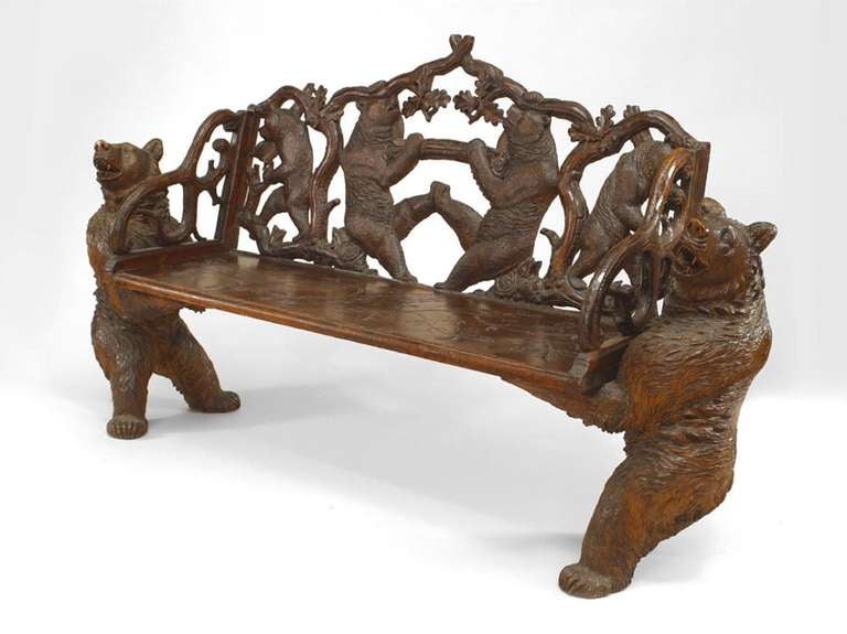 Nineteenth century rustic Black Forest loveseat composed of walnut carved with bear sides supporting a flat, plank seat and filigreed, bear design back.