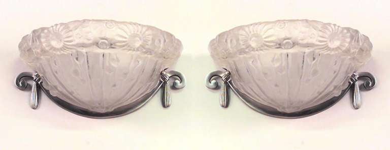 Pair of French Art Deco molded glass wall sconces with a half-round shape, floral design, and chrome brackets (PRICED AS Pair)
