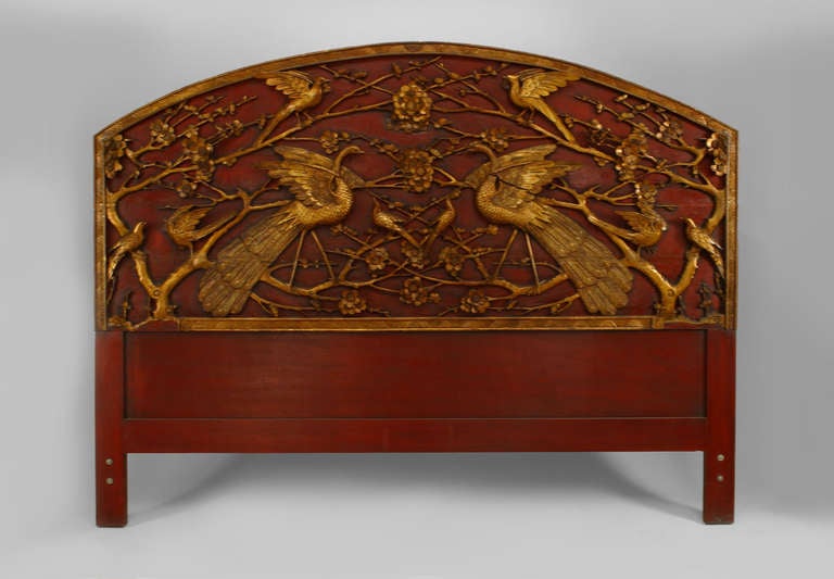 Nineteenth century Chinese red and gilt lacquered headboard with a rounded top and intricate floral and bird design carving.
