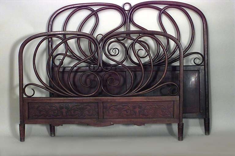 Designed by J & J Kohn, this mahogany stained bentwood bed features curved head and footboards swelling with decorative scroll form tendrils.

J & J Kohn, No. 876, 1900 Catalog.