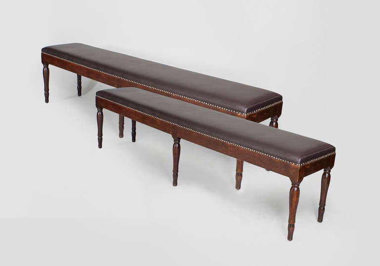 Pair of Italian Neo-classic style (19th Century) walnut long benches with turned tapered legs and upholstered seats (PRICED AS Pair).
