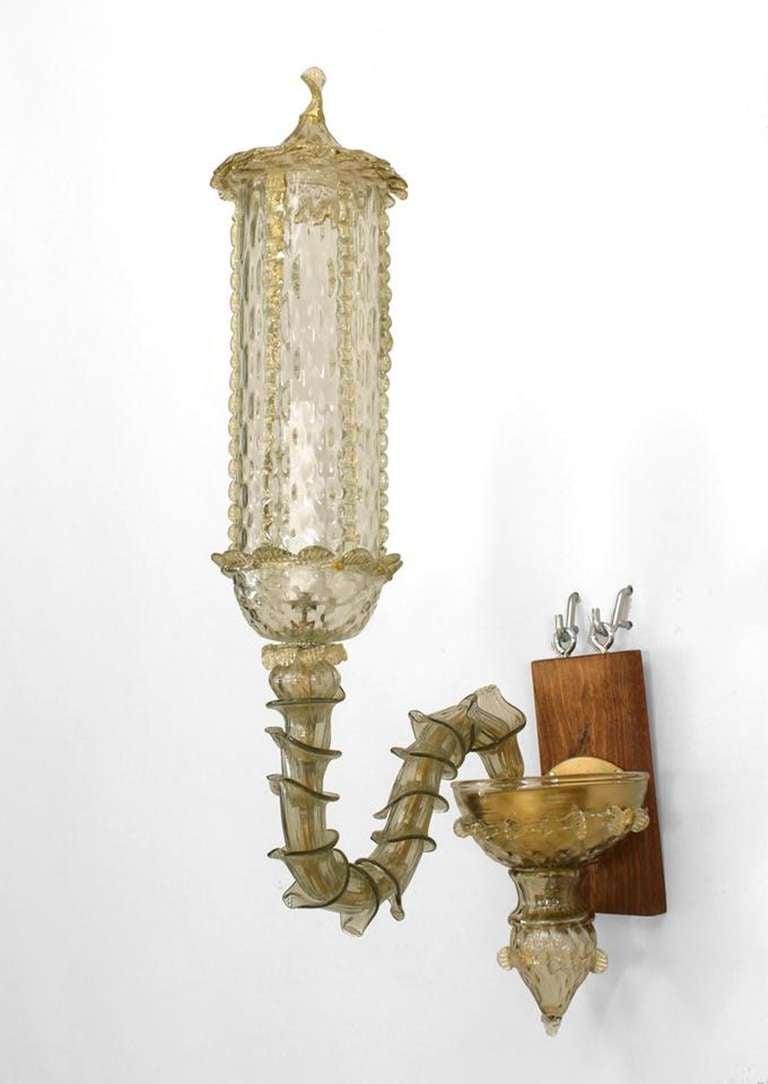 Pair of 1920's Italian Pauli style wall sconces composed of textured light green Murano glass with tall cylindrical hurricane shades topped with pointed covers and joined to bases with scaled scroll arms.