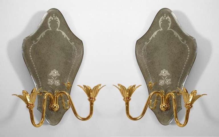 Pair of Italian Murano sconces with shaped mirror back and etched with scroll & flower design with 2 brass scroll shaped arms with modern flower lights. (PRICED AS Pair)

