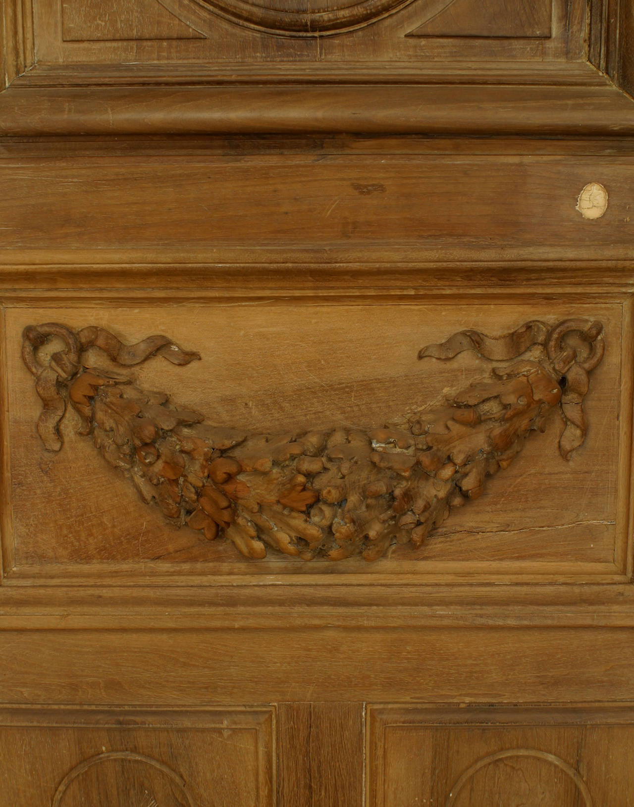 Pair of French Victorian stripped doors with carved top and wreath design.