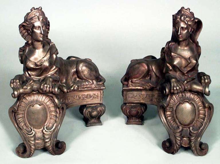 Pair of nineteenth century French Louis XV style andirons composed of bronze dore in the form of adapted Egyptian sphinxes.