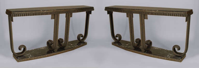 Pair of French Art Deco style console tables composed of scrolling, fluted wrought iron with white veined black marble tops and bases.