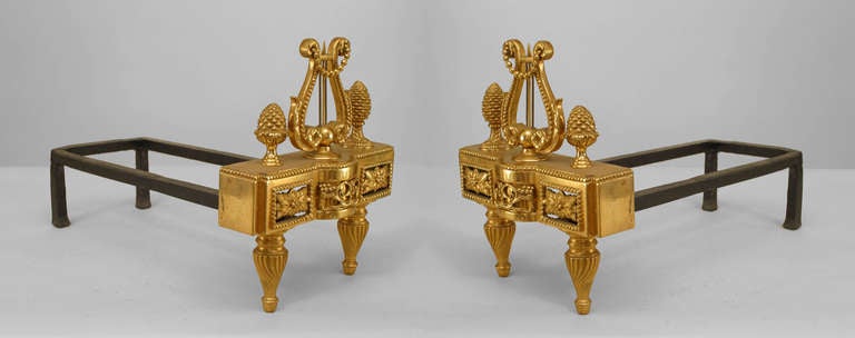 Pair of French Louis XVI-style (19/20th Century) gilt bronze andirons with a lyre centered between two acorn finials (with a double iron shank) (PRICED AS Pair)
