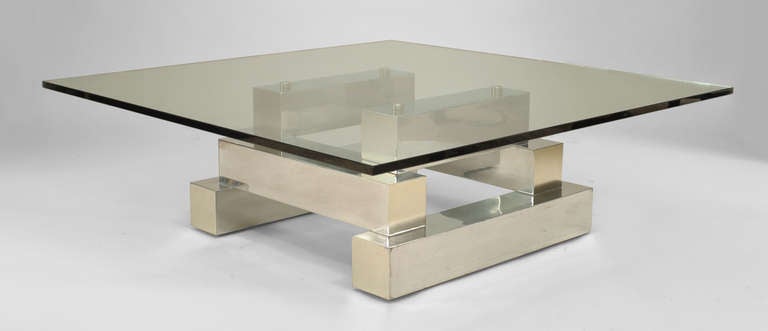 American Modern design aluminum and brass coffee table with a stacked, tiered block design and a square glass top. (in the manner of PAUL EVANS' 