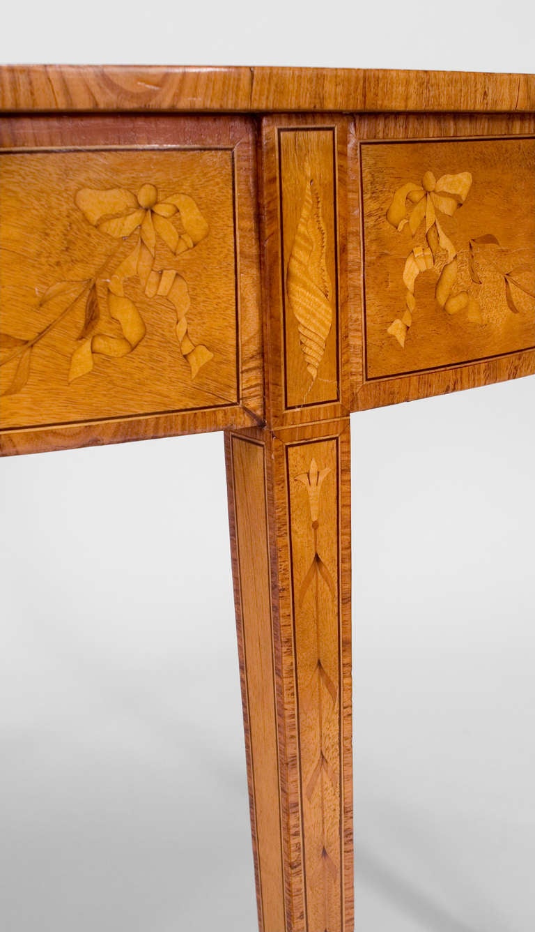 English Georgian satinwood demilune console table with various inlaid flowers and scrolls on apron and top with bronze sabot on feet. (Attributed to Charles Elliott)
