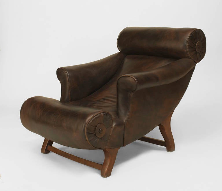 English Arts & Crafts mahogany leg and brown leather upholstered roll seat and back reclining club chair. (designed by WILLIAM BIRCH; labeled HAMPTON & SON, RD #324569)
