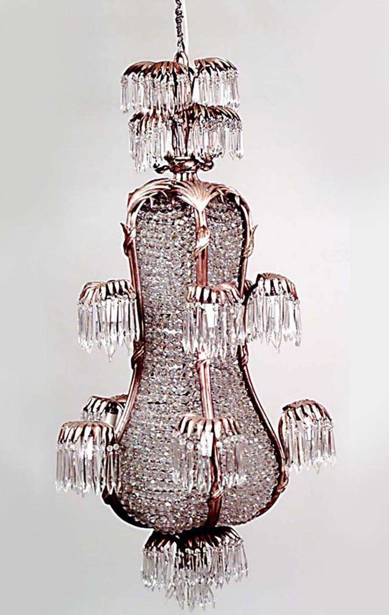 Twentieth century French bronze dore palm design ten arm chandelier with six beaded glass panels and crystal prism drops.