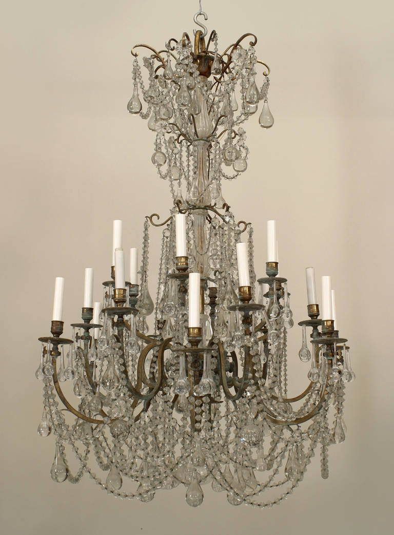 Turn of the twentieth century French crystal and bronze eighteen-arm chandelier with beaded crystal swags and large crystal tear drops.